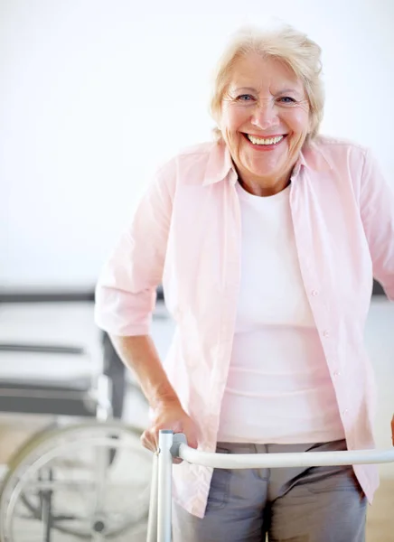 Pleased with her progress. Portrait of a delighted female patient getting to grips with her new zimmer frame
