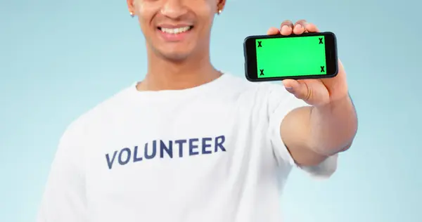电话和绿色屏幕与志愿者在工作室蓝色背景的营销或慈善 空间或广告 以及在带有跟踪标记的显示屏上显示铬钥匙的人 — 图库照片
