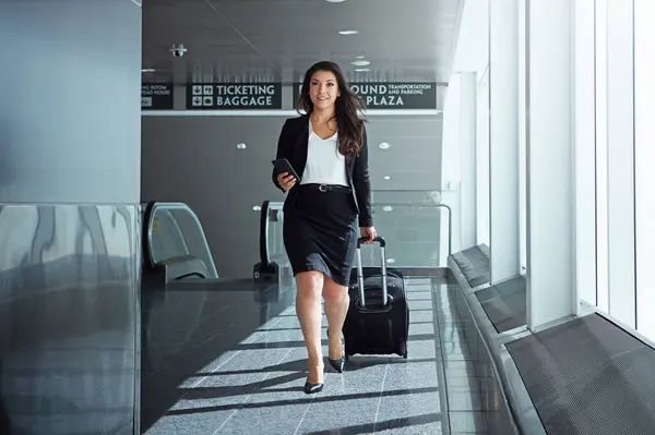 Walking, airport or businesswoman with phone, luggage or suitcase on social media for booking. Travel, airplane or corporate lady texting to chat on mobile app on international flight transportation.
