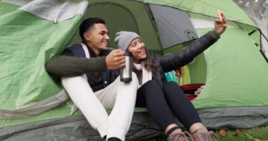 Mutlu çift, çadır ve kamp için selfie, fotoğraf ya da sosyal medya tatilde ya da tatilde doğada dinleniyor. Erkek ve kadın fotoğraf çektirmek, seyahat etmek ya da açık havada kamp yapmak için gülümsüyor..