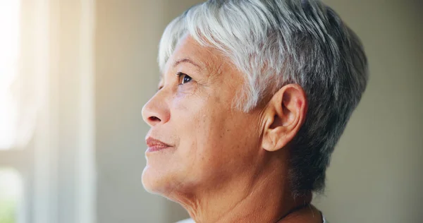 上了年纪的女人 在退休的家里 在回忆 抱负或梦想中思考问题 凝视着窗外 为家中的想法或希望而惊奇 沉思或思考的成熟女性的身体或面部 — 图库照片