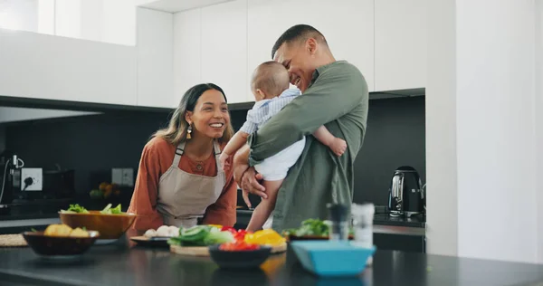 Family, smile and play in kitchen, love and bonding or fun, relax and support or laughing at home. Happy parents and baby, connect and humor or cooking, nutrition and healthy food or care for child.