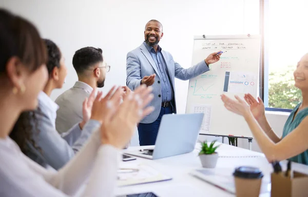 Training, success and black man with presentation in meeting for strategy and progress in startup. Business growth, coach and businessman teaching staff about planning, profit and applause for team.