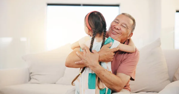 Grandfather, grandchild and smile in hug, love and bonding in retirement, care and relaxing. Happy mexican people, sofa and welcome in visit, greeting and embrace on couch, excited and connection.