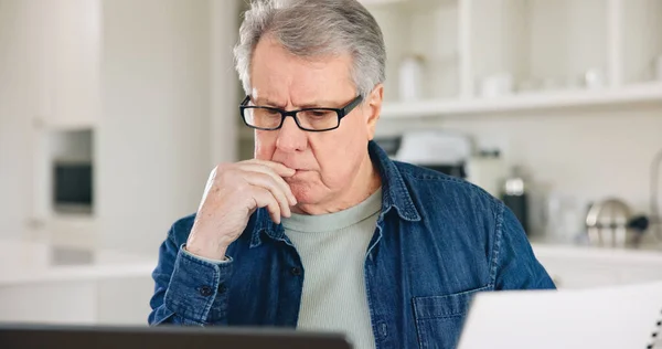 Thinking, laptop or elderly man with paperwork planning for financial spreadsheet or retirement investment. Documents, web or senior person reading news online or savings account or banking in home.