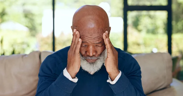 Headache, senior man and stress in home for mistake, mental health or brain fog in retirement. Depressed, tired and frustrated african guy with migraine, crisis and pain of vertigo, trauma or fatigue.