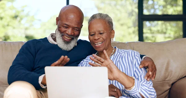 Happy senior couple, video call and laptop in home for voip communication, social network or chat. African man, woman and wave hello on computer in virtual conversation, contact or talk in retirement.