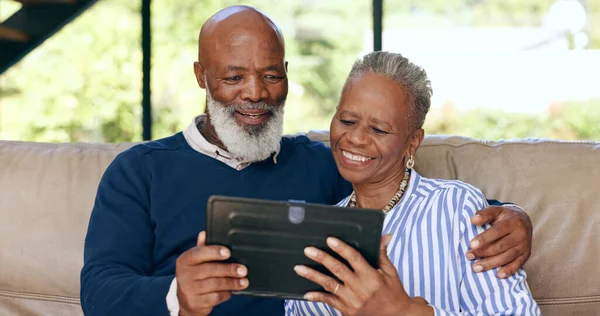 Tablet, video call and senior couple on a sofa for web communication, network or chat at home. Digital, app and old people in living room with love, social media or streaming subscription in a house.