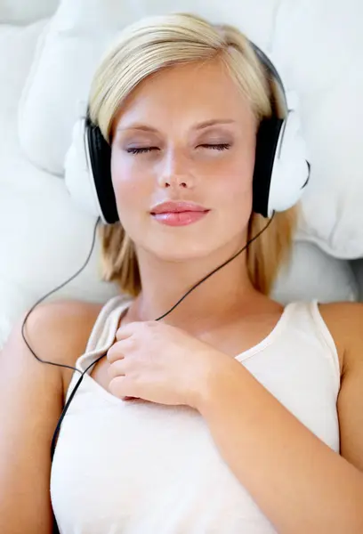 Home, headphones and woman with music, streaming sound and listening with radio, peace or calm. Zen person, technology or girl with headset, podcast audio or playlist with connection, bedroom or song.
