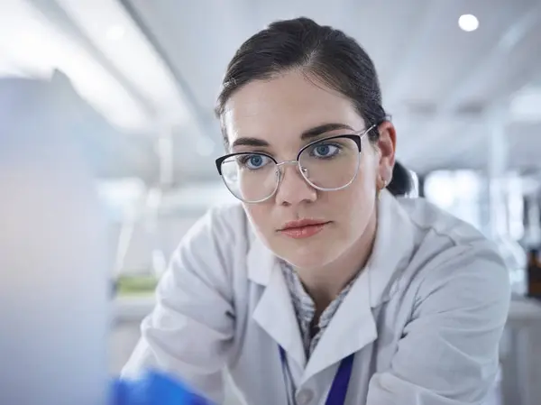 Woman, scientist and lab study future medicine for research discovery, vaccine technology or results review. Female person, glasses and thinking breakthrough for antibiotic, help pills or innovation.