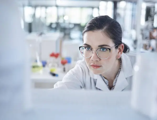 Woman, medical research and lab thinking for vial discovery or future vaccine, review or health technology. Female person, glasses in study breakthrough or antibiotic, help results or innovation idea.