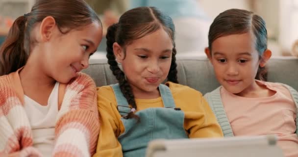 ゲーム アプリやソファの上の映画のためのタブレットで幸せな ストリーミング漫画や子供たち 話していると女の子の子供たちは ウェブ上で見るか学ぶ コメディのためのホームソファの上に技術を持っています — ストック動画