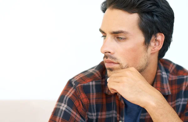 stock image Man, thinking and serious or hands for question, idea and contemplating in living room of apartment or home. Person, face and mental health or thoughtful on couch in lounge for anxiety on weekend.