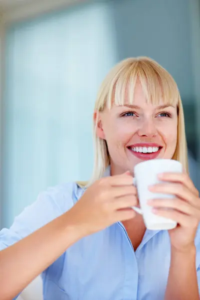 Smile, coffee and young woman at her home relaxing on a weekend morning for calm mindset. Happy, mug and female person from Australia drinking cappuccino, latte or tea with positive attitude at house.