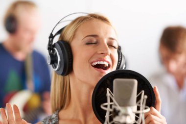 Music, voice and woman with microphone, headphones and band performance with singing talent. Recording studio, art and girl musician live streaming song for record label, sound and happy audio singer. clipart