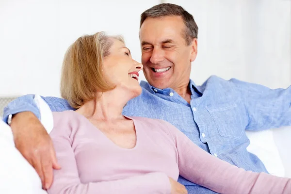 シニア カップル フェイス またはソファーで笑い サポート 退職後の家庭で結びついています 高齢者 リラックスしたリビングルームのソファーで笑顔で家での愛 — ストック写真