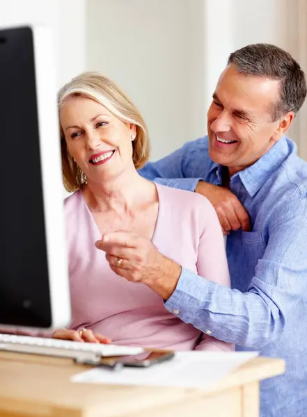 Budget, mature or happy couple with computer for retirement savings, news or pension in home. Planning, funny joke or senior man talking to a woman for house bills, profit growth or research online.