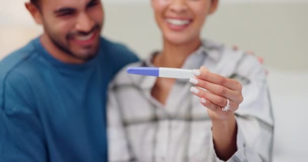 Couple, hands and pregnancy test for positive result, smile and happiness for baby, fertility and love. People, pregnant and celebrate for future, maternity and support at home, embrace and bonding.