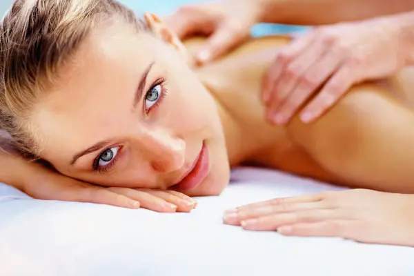Woman, portrait and massage back with spa therapist for wellness, holistic therapy or cosmetic care at holiday resort. Beauty salon, skincare and face of client relax for treatment, break or vacation.