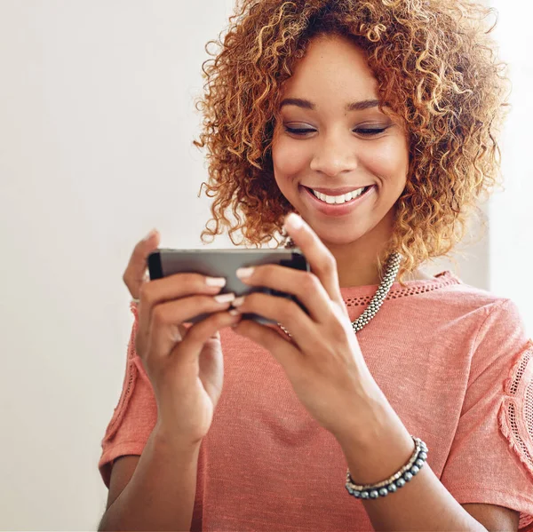 Phone games, relax or happy woman on break playing online gaming, subscription or connection. Designer, video gamer or African person with mobile app in workplace for streaming multimedia with smile.