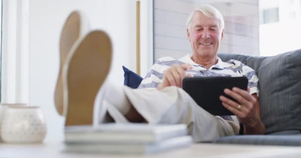 在家里与社交媒体 搜索或电子书一起坐在沙发上的小桌子 放松和老年人 在客厅里带着数字 应用或网上购物 阅读或流口水的笑 脸和老男人 — 图库视频影像