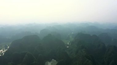 İnsansız hava aracı, manzara ve Vietnam 'da ormanın, doğanın ve çevrenin gökyüzünde sis olan dağlar. Yeşil, tepeler ve bulutlar ufukta tropikal ormanda, kırsalda ya da ormandaki çalıların büyümesinde.
