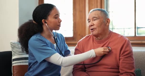 护士和检查心脏跳动的老年人护理在客厅沙发上为家庭医疗保健 在家中监测老年病人呼吸或呼吸的女性个人 医生或医疗护理人员 — 图库视频影像