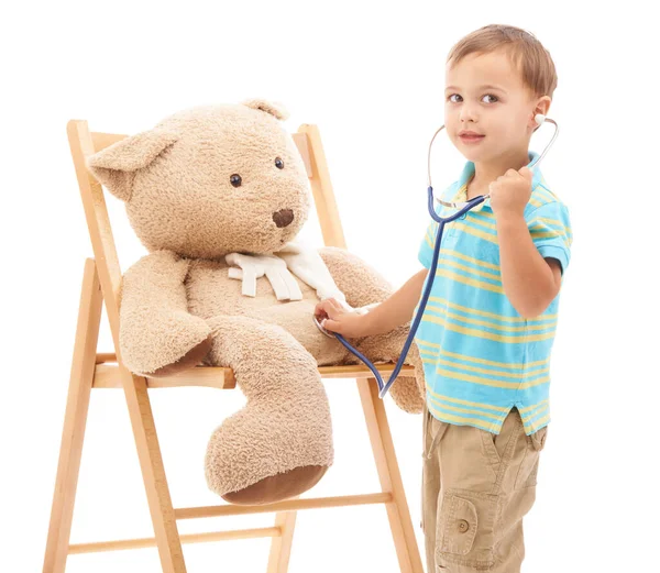 玩具熊和听诊器在工作室里玩医生 听和健康的白色背景 保健游戏和带毛绒玩具的发展 体检或咨询 图库图片