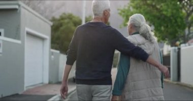 Yaşlı bir çift sabah kucaklaşarak, gülümseyerek ya da aşkla mahallede yürüyorlar. Emeklilik tatilinde rahatla, yaşlı adam ve mutlu kadın sokakta sakin ve sağlıklı bir yürüyüş için sarılıyorlar.