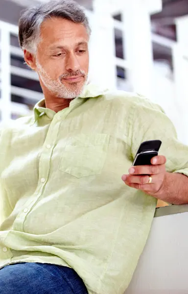 Relax, couch or mature man with phone for social media, message or news update with notification. Technology, chat or senior entrepreneur with mobile app for networking, communication or texting.