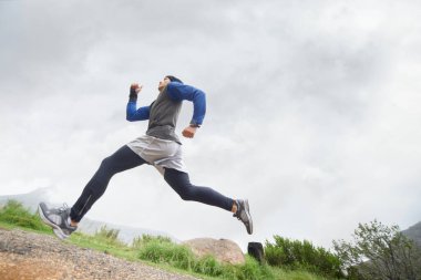 Düşük açı, koşucu ve doğa eğitiminde koşan adam, kardiyo egzersizi ve sağlık için dayanıklılık egzersizi. Spor, spor ya da sağlıklı erkek sporcu dağda hızlı koşuyor, hızlı ya da hareketli..