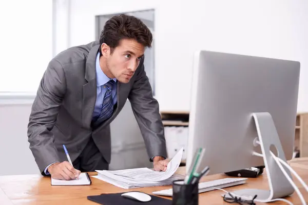 Business man, writing notes and computer for planning, reading report and planning and documents review. Accountant or auditor with notebook, bookkeeping paperwork and priority or list in his office.