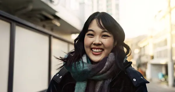 Happy, laughing and face of Asian woman in the city on vacation, adventure or weekend trip. Smile, travel and portrait of excited young female person with positive attitude in urban town on holiday