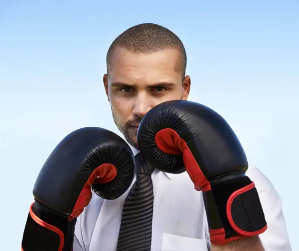 Business man, portrait and boxing gloves for attack or warrior, self defence and fitness for power. Male person, strong and equipment for fight or corporate challenge, exercise and sky background.