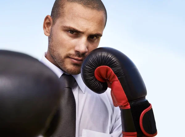 Business man, portrait and boxing gloves for attack or warrior, self defence and fitness for power. Male person, strong and equipment for fight or corporate challenge, exercise and sky background.