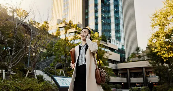 City, phone call and woman with business, conversation and walking with network, digital app or communication. Japan, person or worker with a smartphone, connection and speaking with contact or smile.