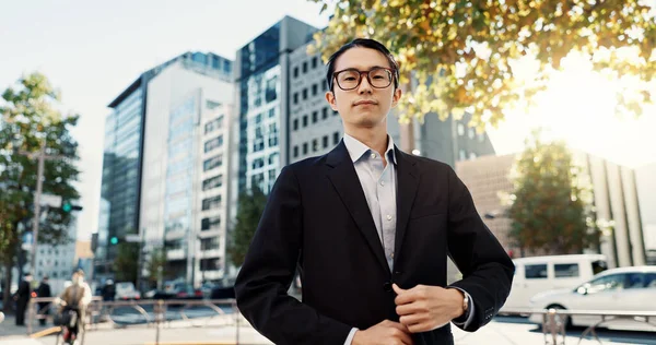 Businessman, portrait and confidence in city street as broker in financial market, professional or Tokyo. Male person, face and corporate career outside business building or sidewalk, worker or pride.