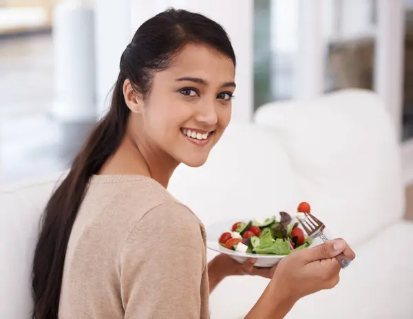 Happy woman, portrait and salad bowl for diet, nutrition or healthy snack sitting on sofa at home. Face of female person smile in relax with mixed vegetables, vitamin or meal for weight loss at house.