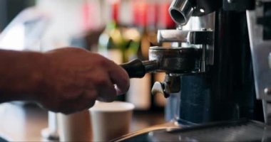 Kahve makinesi, kahve öğütücü ve kahveciyle espresso dolduran eller, küçük işletmeler ve misafirperverlik. Cappuccino, fasulye ve servis, bistro 'da ya da restoranda sıcak içecek, latte ya da taze bira olan biri.