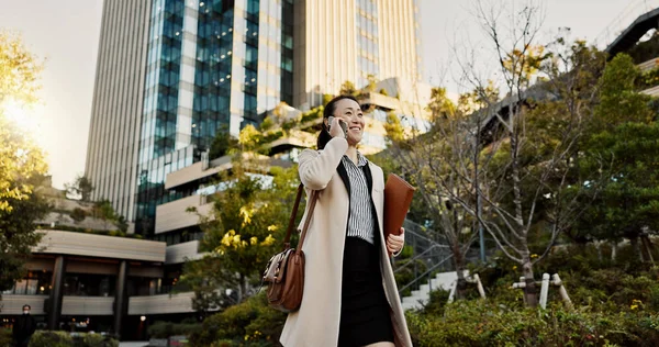 Cit, phone call and woman with business, speaking and walking with network, digital app and communication. Japan, person and worker with a cellphone, connection or smile with contact and professional.