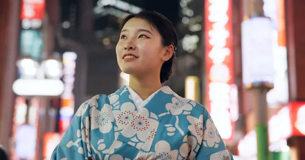 Thinking, Japanese woman and smile with decision, travel and opportunity with wonder, night and lights. Person, outdoor and girl in the streets, relax and evening with peace, commute and thoughts.