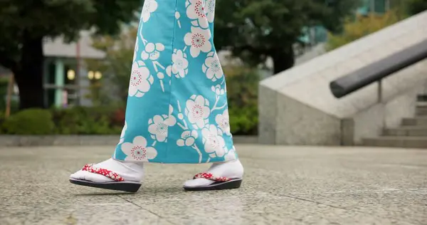 Person, Japanese and feet walking in kimono in city or local commute or traditional, outdoor or downtown. Legs, sandals and Tokyo street or urban road journey as healthy wellness, culture or trip.