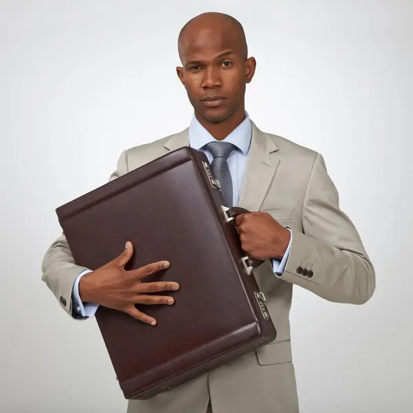 Businessman, portrait and briefcase as corporate in studio for professional deal, white background or financial advisor. Black person, serious face and protect bag for company, growth or mockup space.