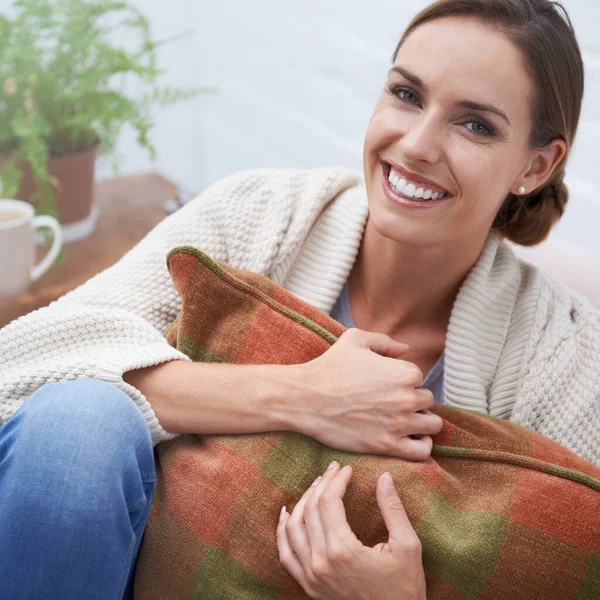 Woman, portrait and happy on sofa with relax, confidence or comfortable in living room of apartment. Person, face and smile on couch of lounge with comfort, chilling or sitting for day off in home.