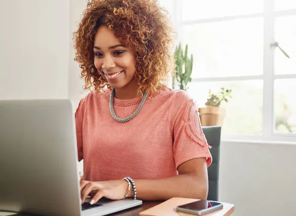 Smile, typing or woman with laptop for research, editing or copywriting on blog or website. Happy African person, internet or female worker in workplace working on update, networking or reading news.