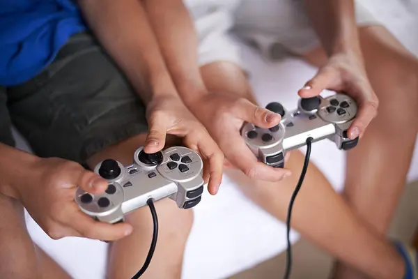 Children, hands and video game controller in a house for gaming, subscription or entertainment closeup from above. Gamepad, zoom and gamer boy kids at home with esports, competition or challenge.