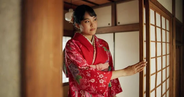 Japanese, woman and kimono in corridor for tradition, tea ceremony and hallway of Chashitsu room or door. Entrance, person and vintage dress or fashion for temae, ritual and waiting for hospitality.