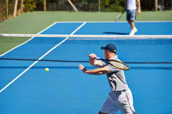 Athlete, man and tennis on court with workout, competition and performance outdoor with fitness and energy. Sport, player and ball on turf for training, exercise and racket with serve, game and hobby.