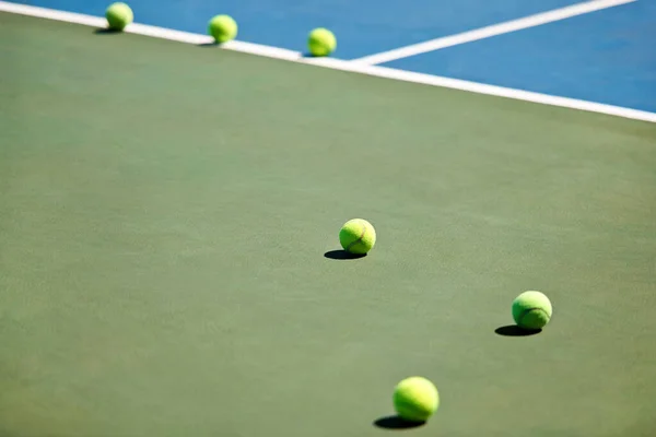 Sport, fitness or tennis balls on court for training, exercise or competitive match to start in summer. Green, background or floor for health or hobby with equipment on the ground ready for a game.