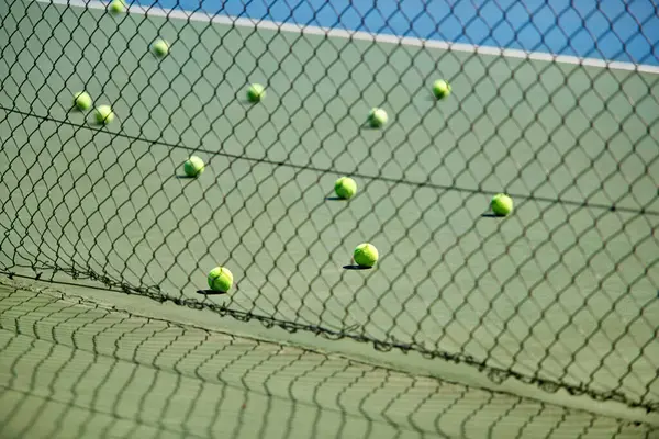 Sport, fitness or tennis balls on floor for training, exercise or competitive match to start in summer. Green, background or court for health or hobby with equipment on the ground ready for a game.